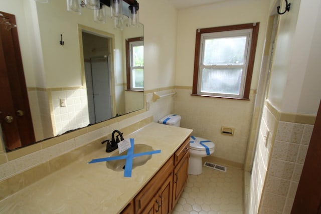 680 Oak Grove Rd, Goodspring, TN 38460 - bathroom with tile walls, vanity, toilet, tile patterned flooring, and a wainscoted wall
