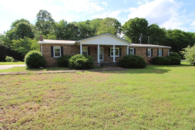 680 Oak Grove Rd, Goodspring, TN 38460 - ranch-style home featuring covered porch, brick siding, a front yard, metal roof, and a chimney