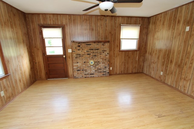 680 Oak Grove Rd, Goodspring, TN 38460 - unfurnished living room featuring a ceiling fan, plenty of natural light, light wood-style floors, and wood walls
