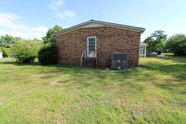 680 Oak Grove Rd, Goodspring, TN 38460 - view of property exterior with cooling unit, entry steps, brick siding, and a lawn