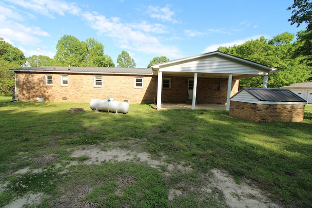 680 Oak Grove Rd, Goodspring, TN 38460 - rear view of property featuring a patio, brick siding, and a lawn