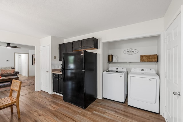 2930 Charlie Sleigh Rd, Woodlawn, TN 37191 - kitchen with freestanding refrigerator, independent washer and dryer, light wood-style floors, light countertops, and a textured ceiling