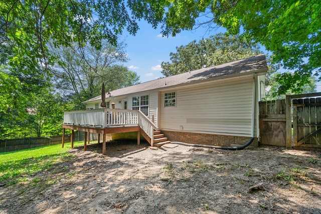 2930 Charlie Sleigh Rd, Woodlawn, TN 37191 - rear view of house with a wooden deck and a gate
