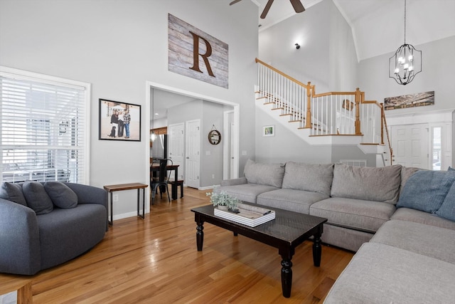 6523 Brigade Ln, Hixson, TN 37343 - living area featuring stairs, high vaulted ceiling, light wood-style floors, ceiling fan, and a chandelier