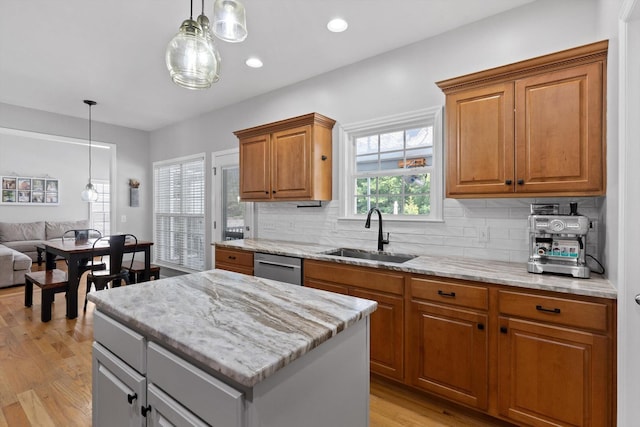 6523 Brigade Ln, Hixson, TN 37343 - kitchen featuring a sink, stainless steel dishwasher, a center island, tasteful backsplash, and light wood-style flooring