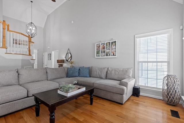 6523 Brigade Ln, Hixson, TN 37343 - living area featuring wood finished floors, high vaulted ceiling, healthy amount of natural light, a chandelier, and baseboards