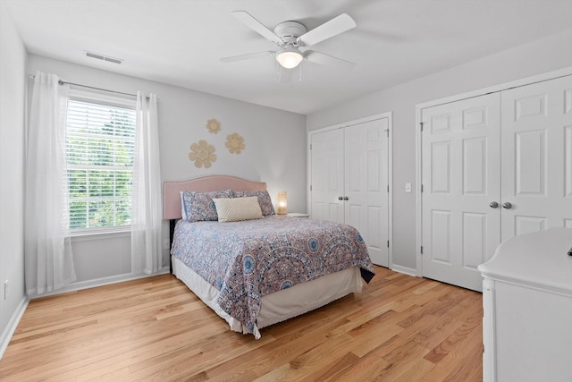 6523 Brigade Ln, Hixson, TN 37343 - bedroom with multiple closets, light wood-style floors, baseboards, and a ceiling fan