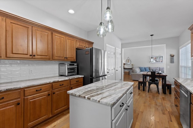 6523 Brigade Ln, Hixson, TN 37343 - kitchen featuring stainless steel appliances, brown cabinetry, and decorative backsplash