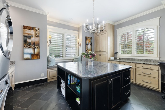 8255 Jamie Ct, Brentwood, TN 37027 - kitchen featuring stacked washer / dryer, dark tile patterned flooring, dark cabinets, a chandelier, and a center island