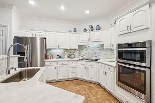 641 Old Hickory Blvd Unit 35, Brentwood, TN 37027 - kitchen featuring stainless steel appliances, a sink, ornamental molding, decorative backsplash, and white cabinetry