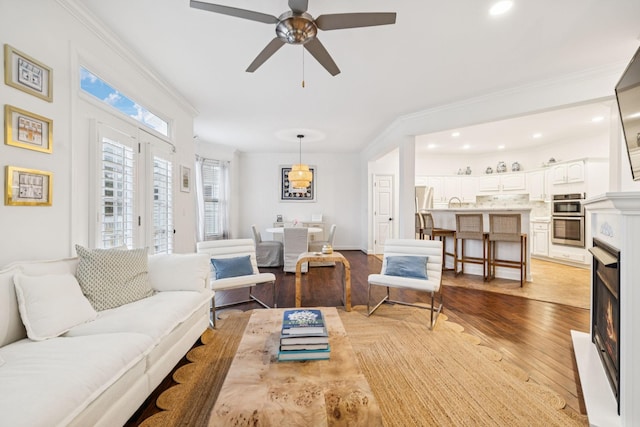 641 Old Hickory Blvd Unit 35, Brentwood, TN 37027 - living room featuring light wood-type flooring, a ceiling fan, recessed lighting, a warm lit fireplace, and crown molding