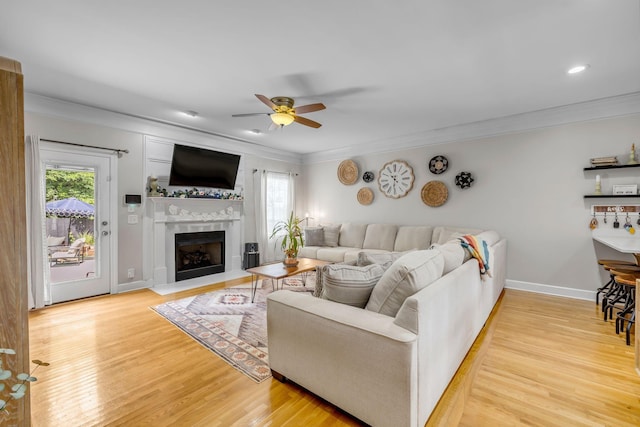 2988 Barnstable Ct, Murfreesboro, TN 37127 - living room with ceiling fan, crown molding, light wood-style flooring, a fireplace with raised hearth, and baseboards