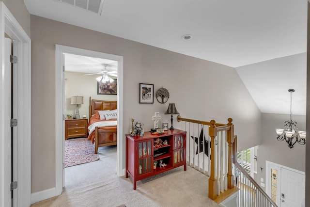 2988 Barnstable Ct, Murfreesboro, TN 37127 - hallway featuring an upstairs landing, light colored carpet, lofted ceiling, a chandelier, and baseboards