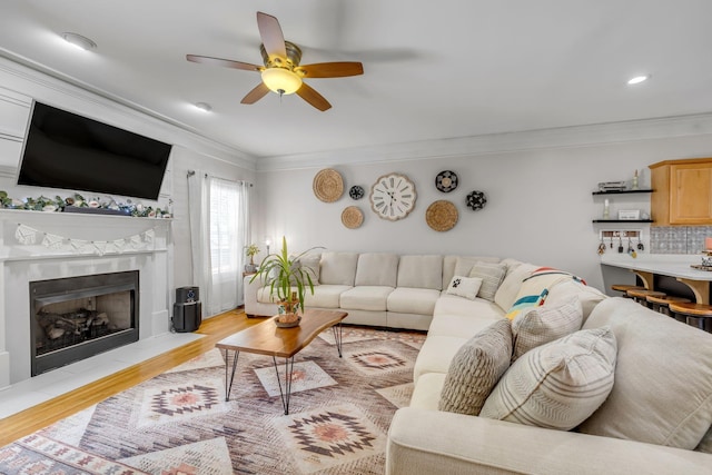 2988 Barnstable Ct, Murfreesboro, TN 37127 - living room with light wood-style flooring, ceiling fan, crown molding, a fireplace with flush hearth, and recessed lighting