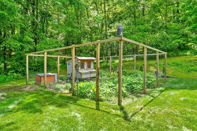 6779 Arno Allisona Rd, College Grove, TN 37046 - view of grassy yard with a garden and a wooded view