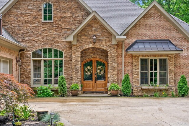 6779 Arno Allisona Rd, College Grove, TN 37046 - entrance to property featuring roof with shingles, french doors, stone siding, and brick siding