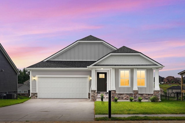 1573 Collins View Way, Clarksville, TN 37043 - view of front of home featuring board and batten siding, driveway, stone siding, and roof with shingles