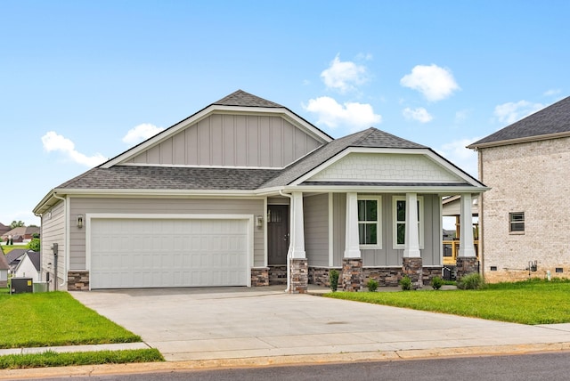1573 Collins View Way, Clarksville, TN 37043 - craftsman-style house with board and batten siding, an attached garage, covered porch, stone siding, and a front lawn