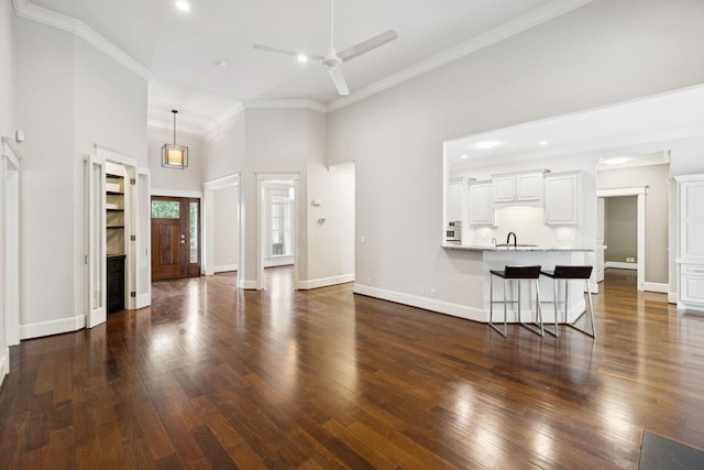 286 Keswick Grove Ln, Franklin, TN 37067 - living area with a ceiling fan, ornamental molding, dark wood-style flooring, a high ceiling, and baseboards