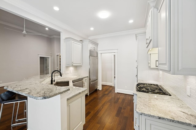 286 Keswick Grove Ln, Franklin, TN 37067 - kitchen with a sink, stainless steel appliances, a peninsula, backsplash, and ornamental molding
