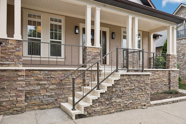 286 Keswick Grove Ln, Franklin, TN 37067 - property entrance featuring stone siding, brick siding, and covered porch