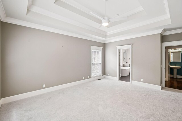 286 Keswick Grove Ln, Franklin, TN 37067 - unfurnished bedroom featuring a tray ceiling, connected bathroom, carpet, crown molding, and baseboards