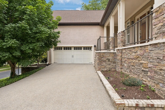 286 Keswick Grove Ln, Franklin, TN 37067 - view of property exterior featuring asphalt driveway, roof with shingles, brick siding, and a garage