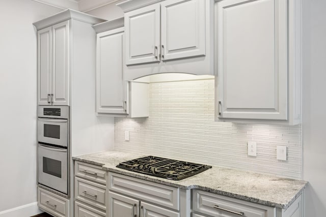 286 Keswick Grove Ln, Franklin, TN 37067 - kitchen featuring black gas cooktop, double oven, backsplash, and light stone counters
