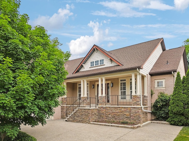 286 Keswick Grove Ln, Franklin, TN 37067 - craftsman inspired home with a porch, roof with shingles, stone siding, and concrete driveway