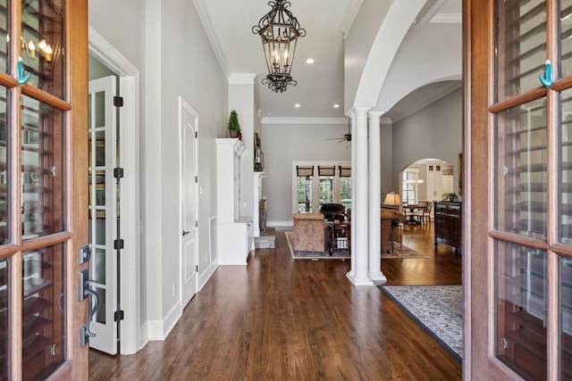 1194 Meadow Bridge Ln, Arrington, TN 37014 - entrance foyer featuring arched walkways, decorative columns, ornamental molding, dark wood-style flooring, and recessed lighting
