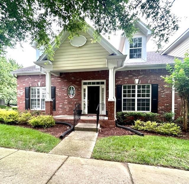 1906 Montgomery Way, Franklin, TN 37067 - view of front facade with brick siding and a porch