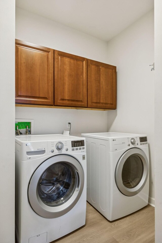 1906 Montgomery Way, Franklin, TN 37067 - laundry room with independent washer and dryer, cabinet space, and light wood-style flooring