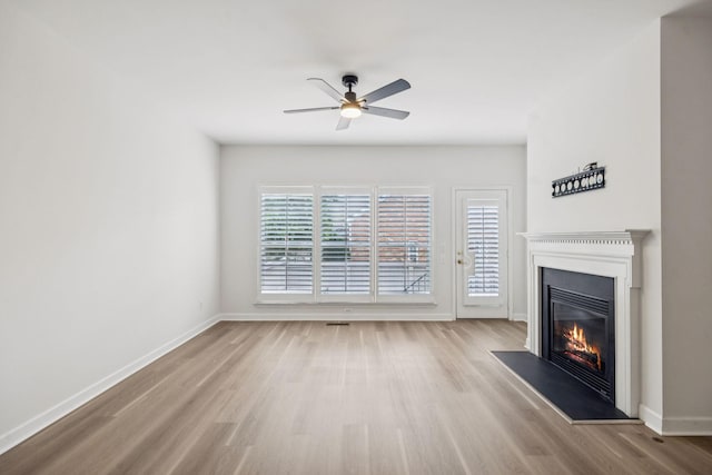 1906 Montgomery Way, Franklin, TN 37067 - unfurnished living room featuring a glass covered fireplace, wood finished floors, and a ceiling fan