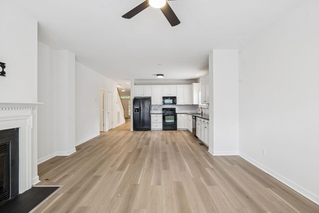 1906 Montgomery Way, Franklin, TN 37067 - unfurnished living room with a ceiling fan, a fireplace, and light wood finished floors