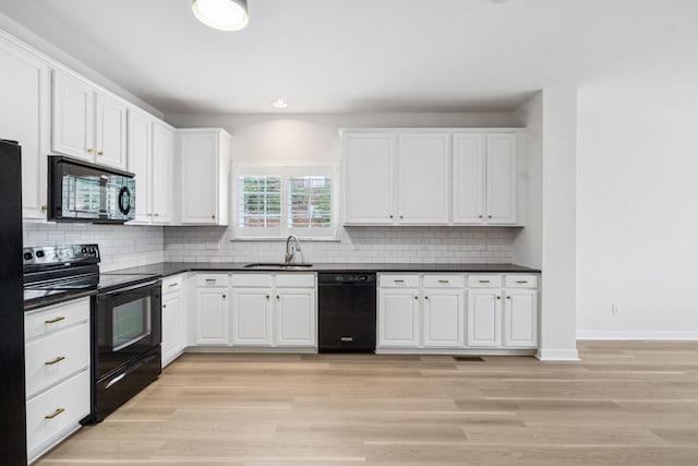 1906 Montgomery Way, Franklin, TN 37067 - kitchen featuring black appliances, dark countertops, white cabinetry, tasteful backsplash, and light wood-type flooring