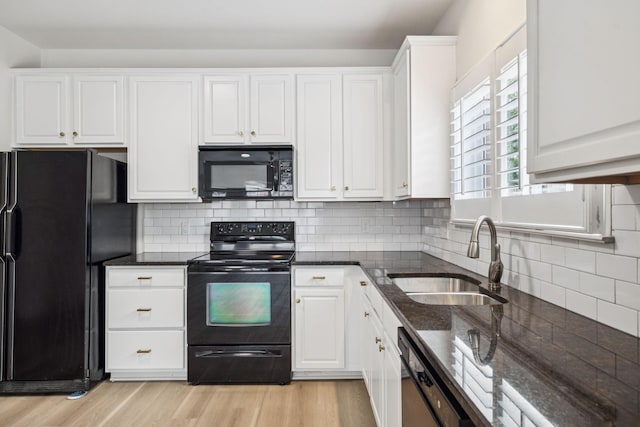 1906 Montgomery Way, Franklin, TN 37067 - kitchen featuring black appliances, white cabinetry, light wood finished floors, and dark stone countertops
