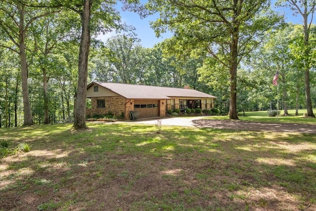 4552 Elkins Dr, Centerville, TN 37033 - view of front of house featuring a garage, brick siding, driveway, and a front yard