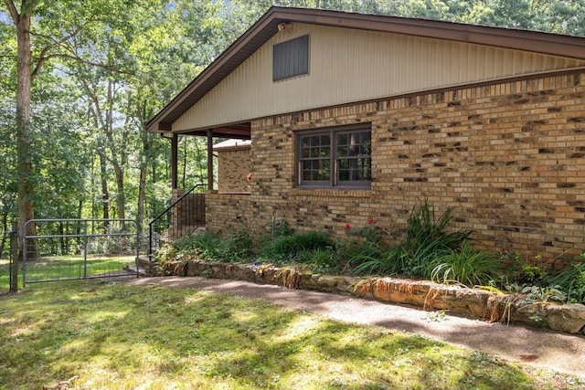 4552 Elkins Dr, Centerville, TN 37033 - view of home's exterior with brick siding and a gate