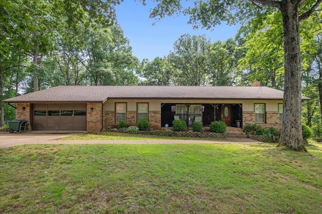 4552 Elkins Dr, Centerville, TN 37033 - ranch-style house featuring brick siding, a garage, concrete driveway, and a front yard