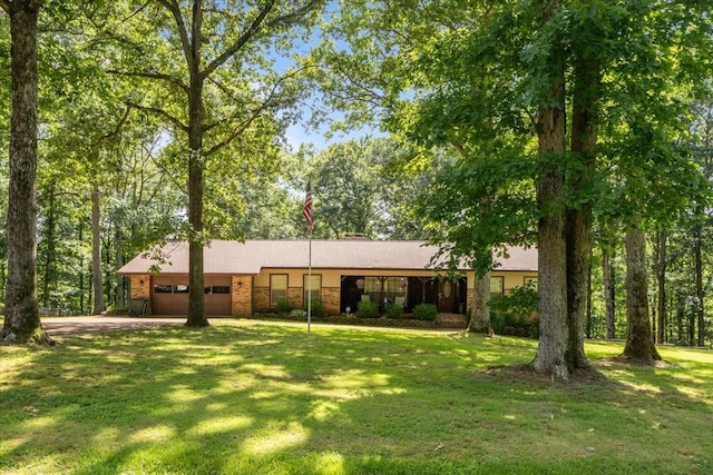 4552 Elkins Dr, Centerville, TN 37033 - view of front of home with an attached garage, driveway, and a front yard