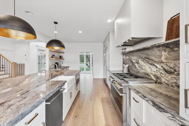205 Well Spring Ct, Brentwood, TN 37027 - kitchen featuring stainless steel appliances, premium range hood, light wood-type flooring, white cabinetry, and recessed lighting