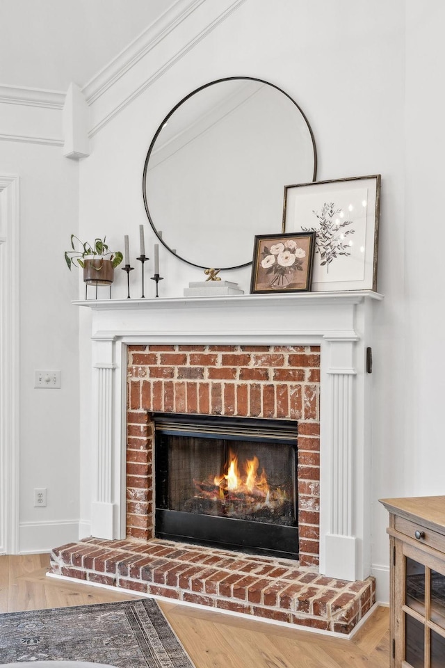 205 Well Spring Ct, Brentwood, TN 37027 - detailed view of a brick fireplace, wood finished floors, baseboards, and ornamental molding