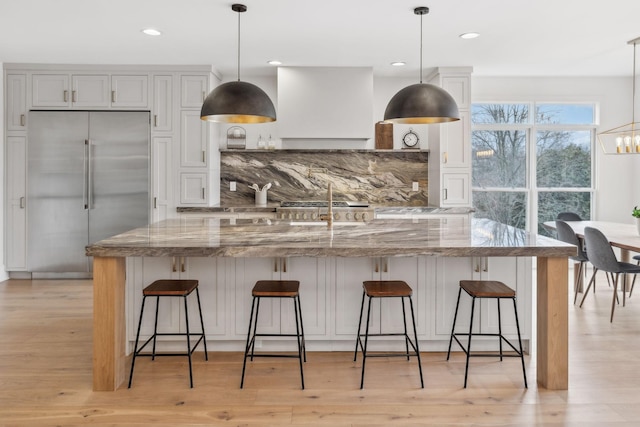 205 Well Spring Ct, Brentwood, TN 37027 - kitchen with stainless steel built in refrigerator, light wood finished floors, light stone countertops, and recessed lighting