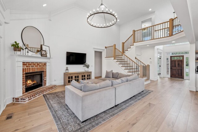 205 Well Spring Ct, Brentwood, TN 37027 - living area with a towering ceiling, stairway, light wood finished floors, ornamental molding, and a chandelier