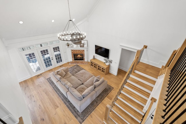205 Well Spring Ct, Brentwood, TN 37027 - living area featuring a chandelier, ornamental molding, light wood-type flooring, a fireplace, and recessed lighting