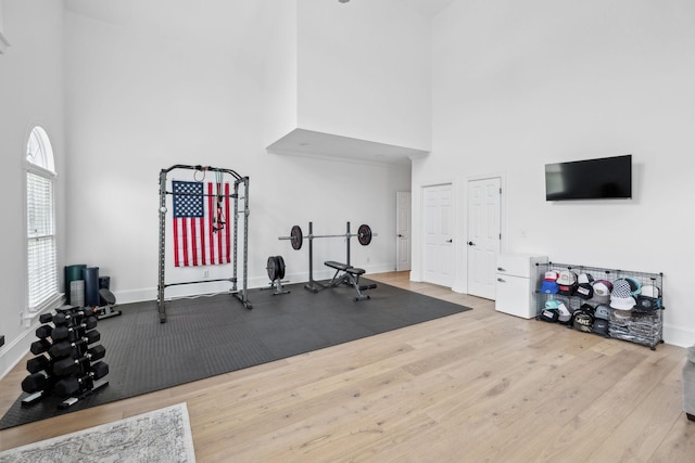 205 Well Spring Ct, Brentwood, TN 37027 - exercise room featuring a towering ceiling, wood finished floors, and baseboards