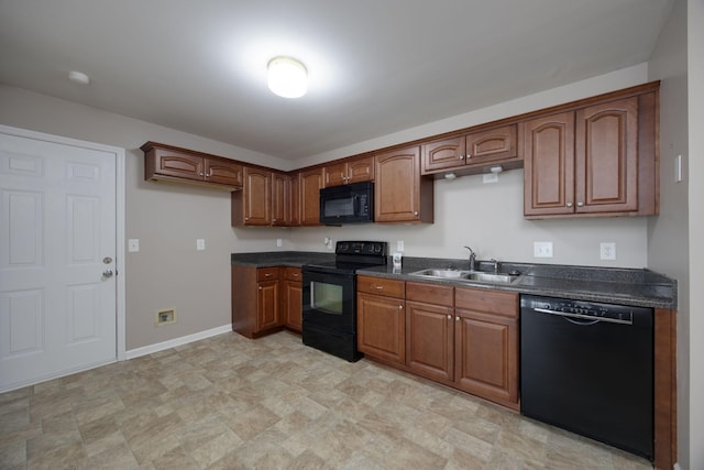 2321 Riverway Dr, Old Hickory, TN 37138 - kitchen with black appliances, a sink, dark countertops, stone finish flooring, and brown cabinetry