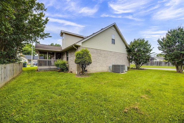 2321 Riverway Dr, Old Hickory, TN 37138 - rear view of property featuring central AC unit, brick siding, and a sunroom