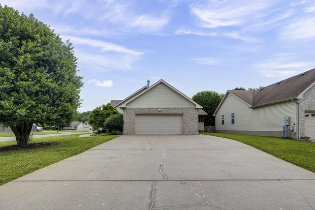 2321 Riverway Dr, Old Hickory, TN 37138 - view of front of home featuring driveway, a front lawn, brick siding, and an attached garage