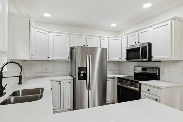 1075 Kathryn Rd, Mount Juliet, TN 37122 - kitchen featuring stainless steel appliances, a sink, tasteful backsplash, light countertops, and white cabinets